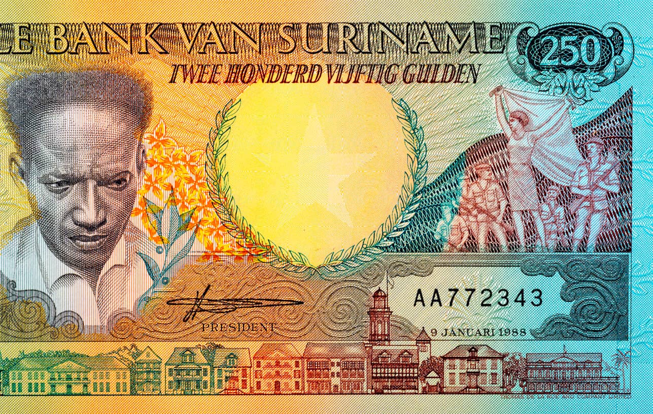Colorful 250-unit banknote with a man's portrait on the left, a large 250 emblem on the right, laurel wreaths, flowers, and a city skyline along the bottom.